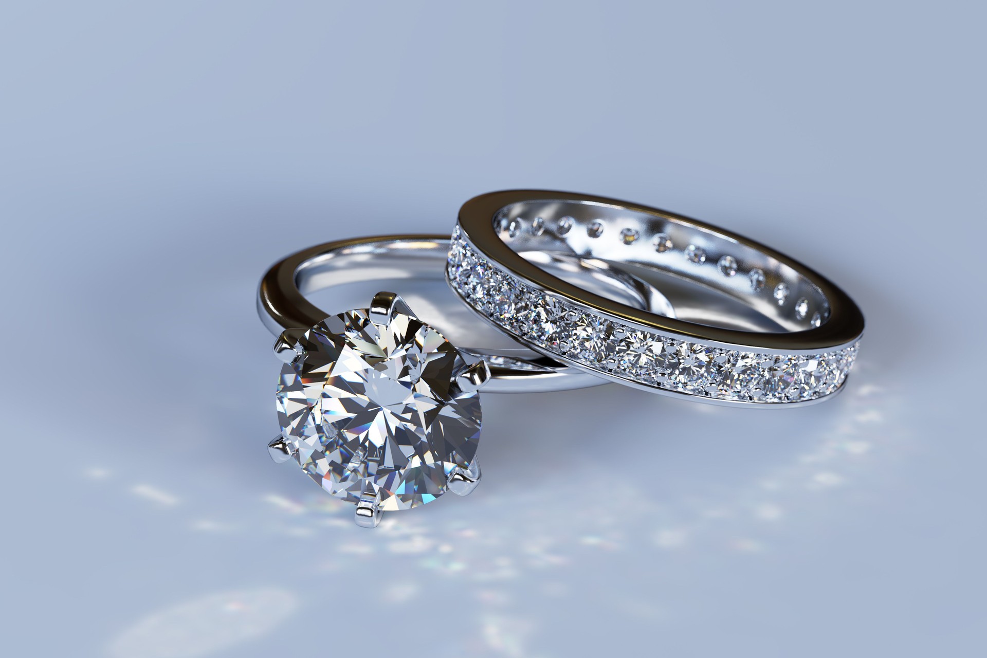 Diamond engagement ring, wedding ring on blue glossy background