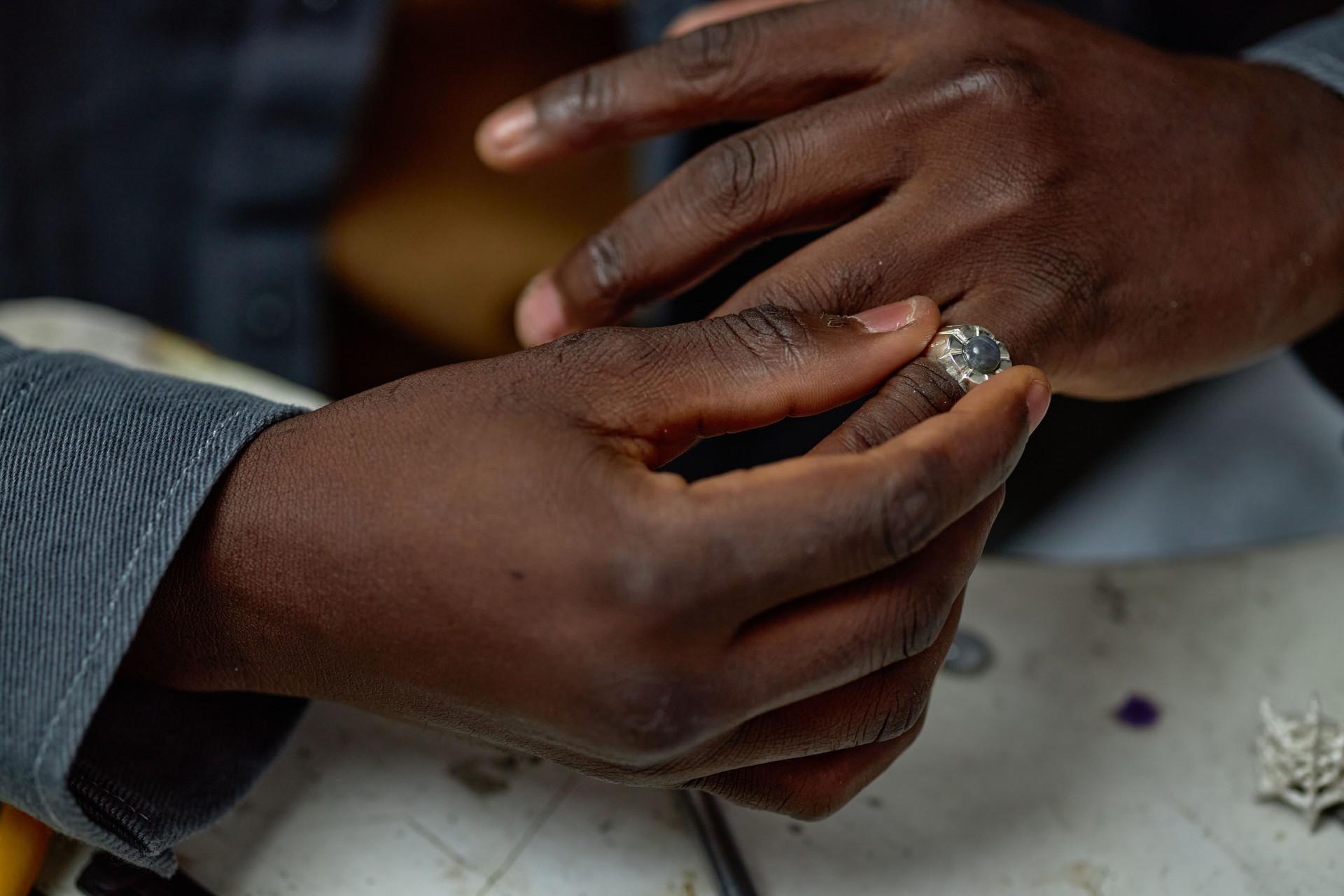 Delicately Handling Gemstone in Jewelry Workshop