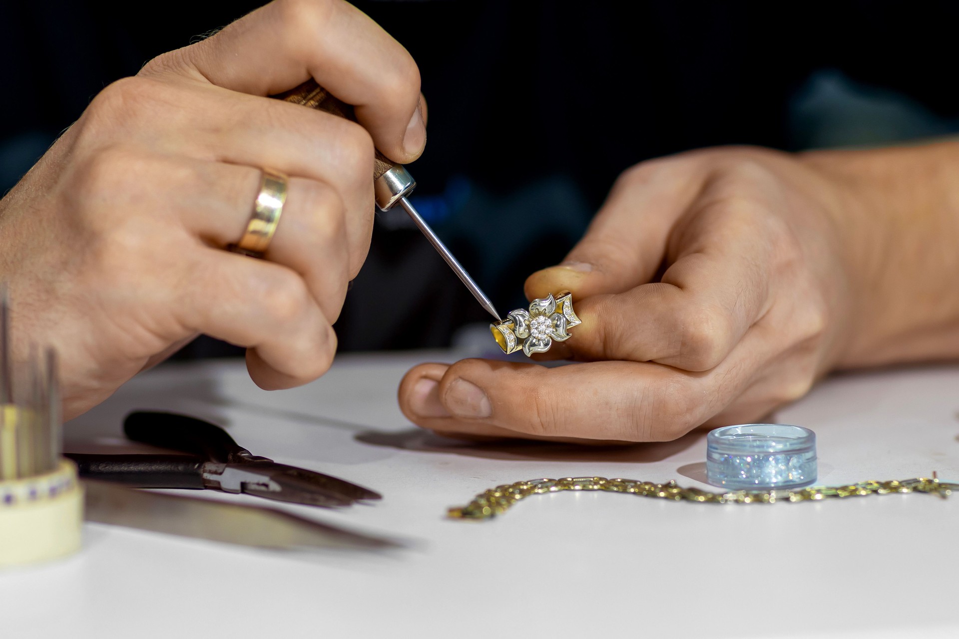 Gold ring with diamonds in the hand of a jeweler